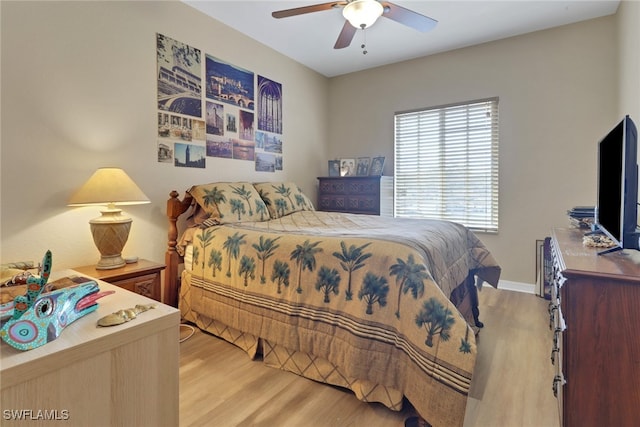 bedroom featuring light wood-style floors, ceiling fan, and baseboards