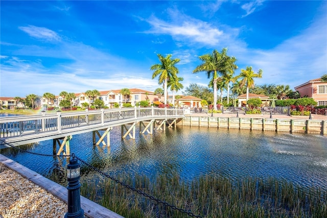 dock area featuring a water view and a residential view