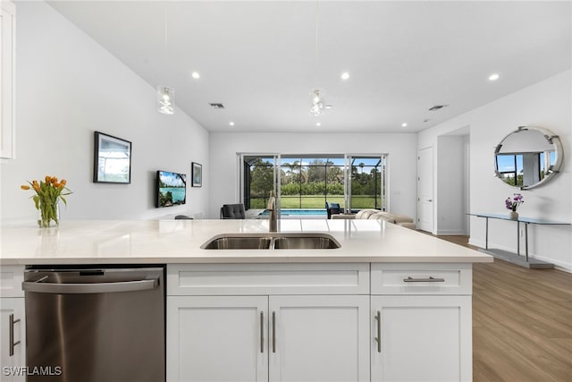 kitchen featuring light countertops, open floor plan, visible vents, and dishwasher