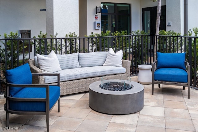 view of patio / terrace featuring an outdoor living space with a fire pit