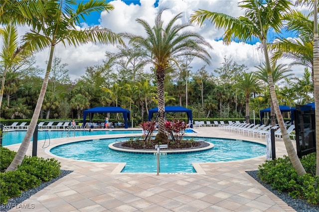 community pool with a patio and a gazebo