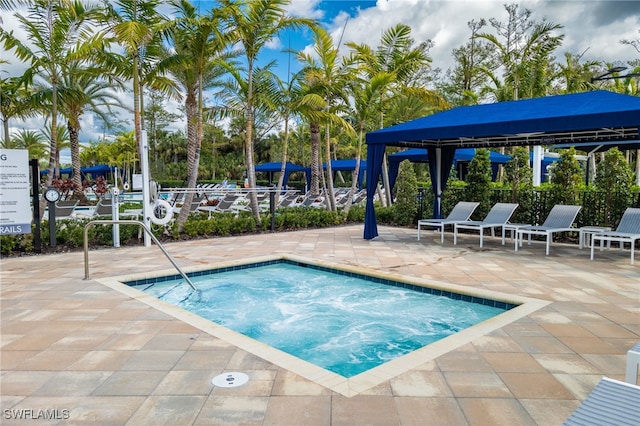 view of swimming pool featuring a patio area and fence