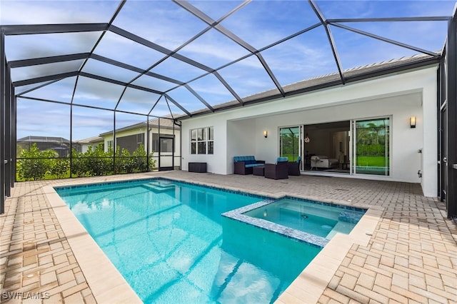 rear view of house with stucco siding, a pool with connected hot tub, glass enclosure, and a patio