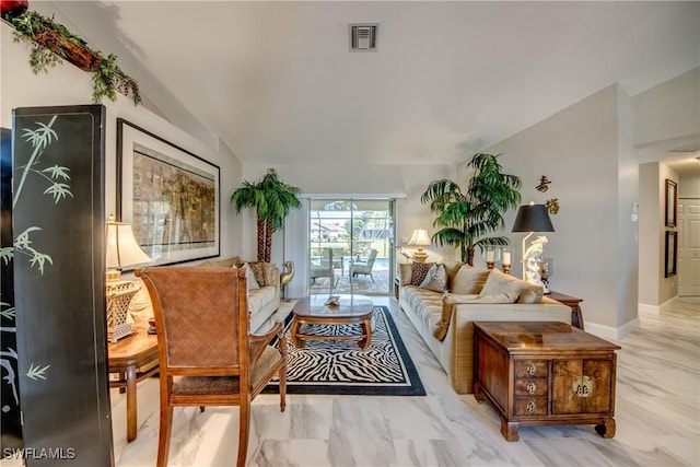 living area with vaulted ceiling, marble finish floor, visible vents, and baseboards