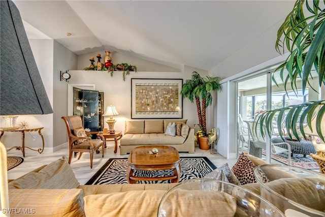 living room with lofted ceiling and baseboards