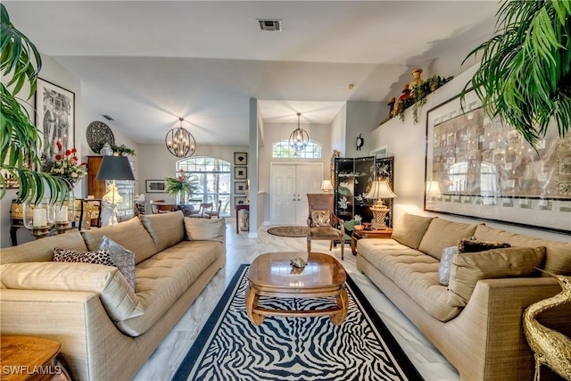 living room with visible vents and a chandelier