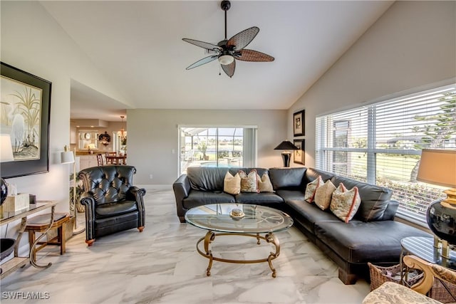 living area with high vaulted ceiling, marble finish floor, and ceiling fan