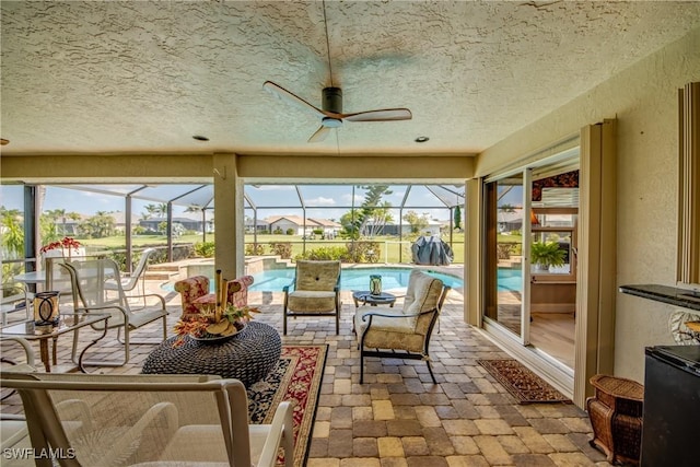 sunroom featuring plenty of natural light and a ceiling fan