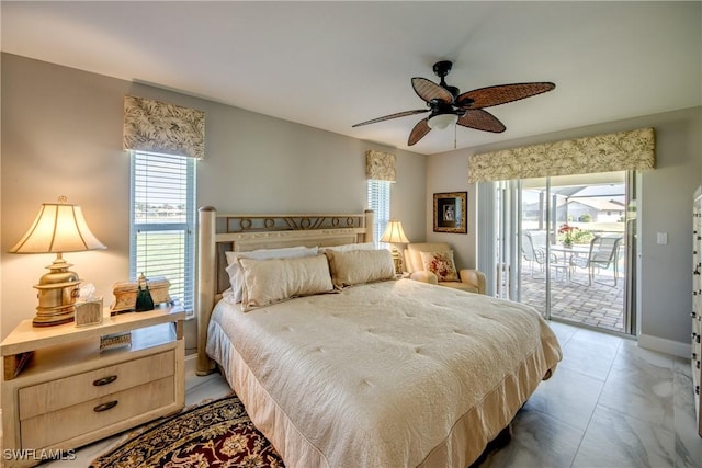 bedroom featuring access to outside, multiple windows, baseboards, and ceiling fan