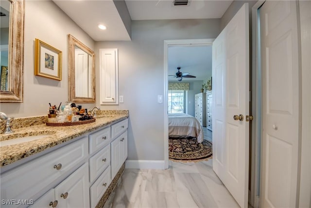 bathroom with baseboards, a sink, ensuite bath, and double vanity