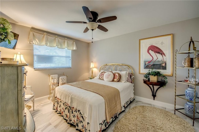 bedroom featuring ceiling fan and baseboards