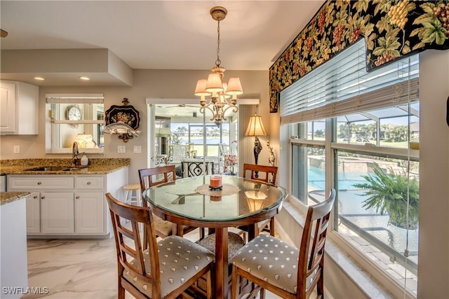 dining space featuring marble finish floor and a healthy amount of sunlight