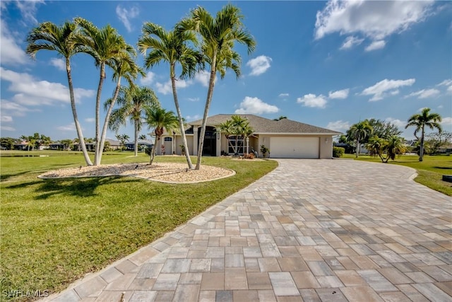 view of front facade featuring a garage, decorative driveway, and a front lawn