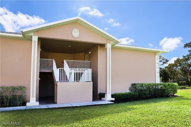 view of home's exterior with a yard and stucco siding