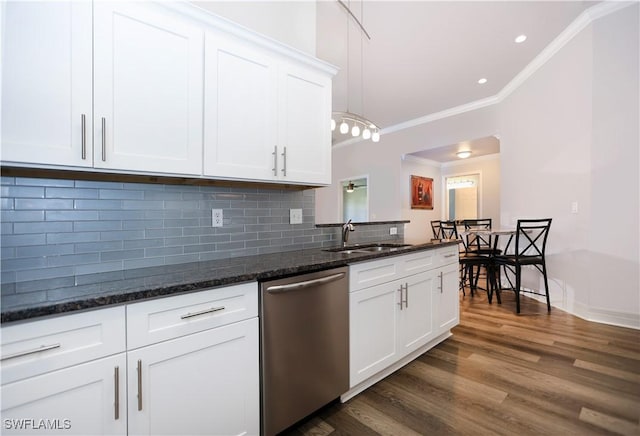 kitchen with a sink, white cabinetry, backsplash, dishwasher, and crown molding