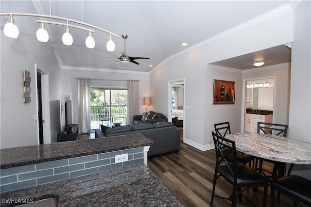 living area with ceiling fan, lofted ceiling, baseboards, ornamental molding, and dark wood finished floors