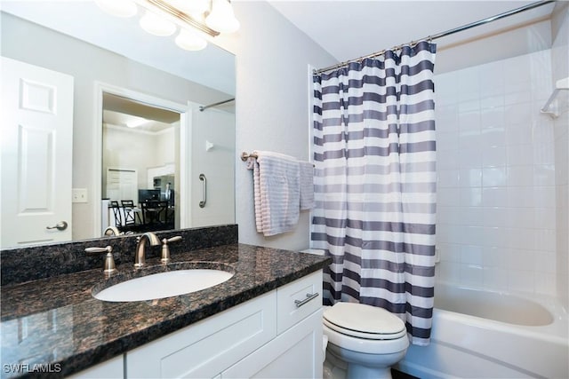 bathroom featuring toilet, vanity, and shower / tub combo with curtain