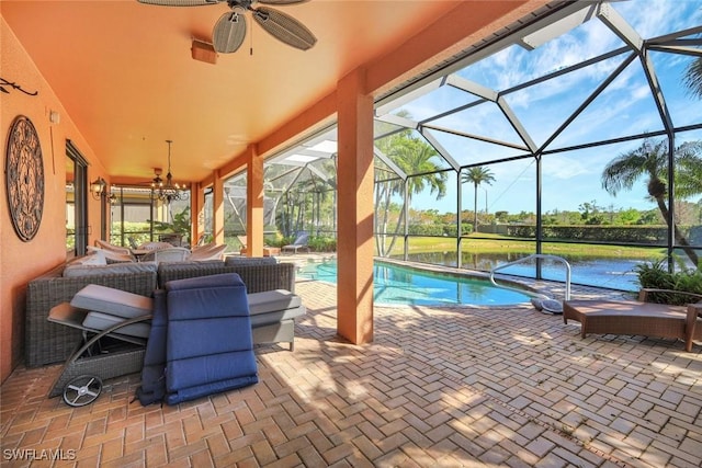 pool featuring glass enclosure, an outdoor hangout area, a ceiling fan, and a patio area