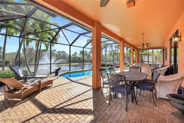 view of patio featuring an outdoor pool, a lanai, a ceiling fan, and outdoor dining space