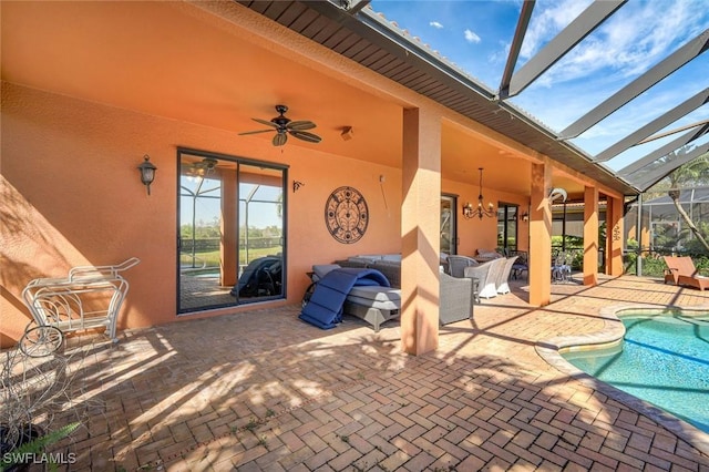 view of patio / terrace featuring an outdoor pool, glass enclosure, an outdoor hangout area, and a ceiling fan