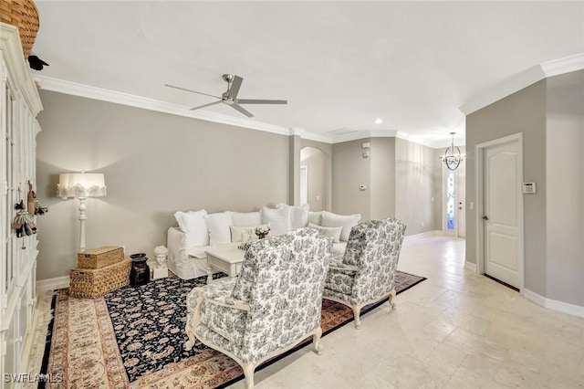 living area with baseboards, arched walkways, ceiling fan, and crown molding