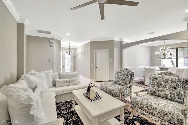 living area featuring ceiling fan with notable chandelier, a healthy amount of sunlight, visible vents, and ornamental molding