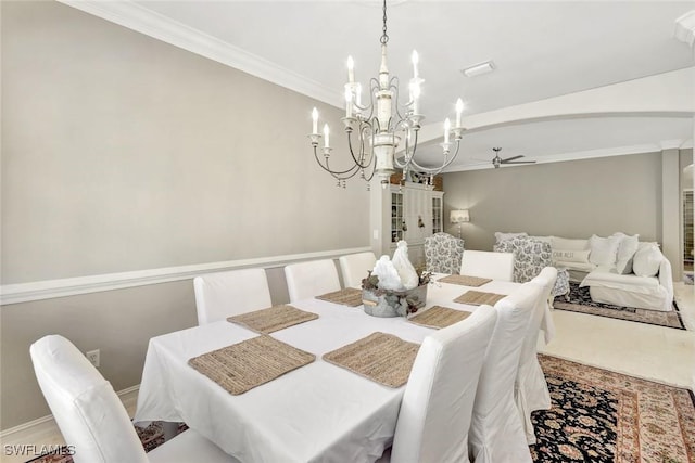 dining area featuring ceiling fan with notable chandelier, crown molding, and baseboards