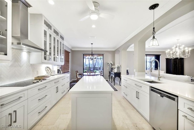 kitchen featuring wall chimney range hood, dishwasher, ceiling fan with notable chandelier, black electric cooktop, and a sink