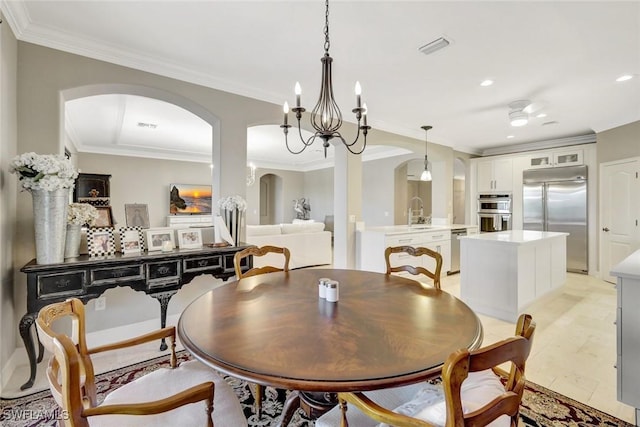 dining space featuring visible vents, recessed lighting, arched walkways, an inviting chandelier, and crown molding