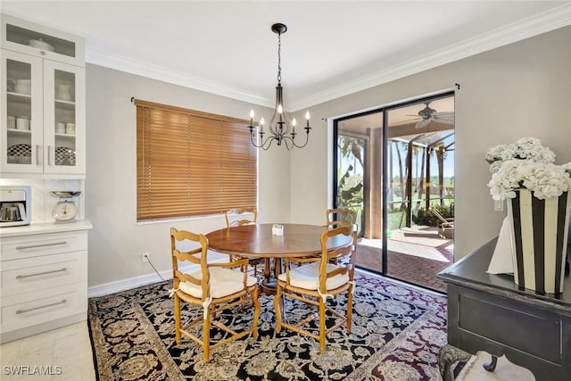 dining area with baseboards, a chandelier, and ornamental molding