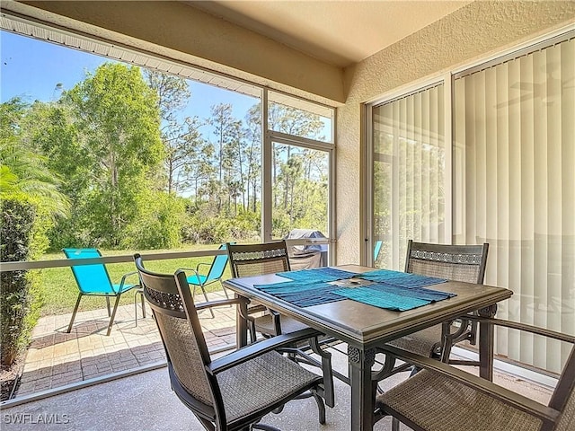 sunroom featuring outdoor dining space