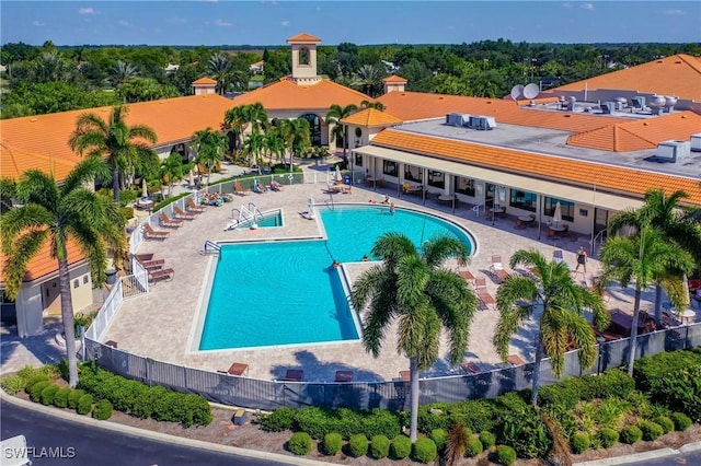 community pool featuring a patio area and fence