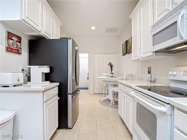 kitchen with white cabinetry and white appliances