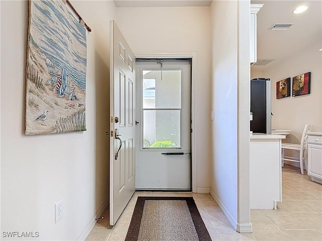 doorway featuring recessed lighting, visible vents, baseboards, and light tile patterned flooring