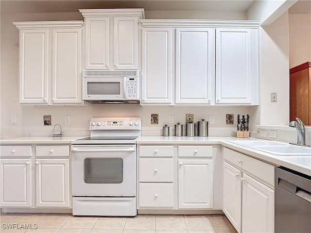 kitchen with a sink, white cabinetry, white appliances, light tile patterned flooring, and light countertops