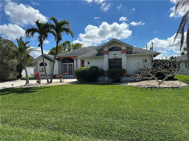 view of front of house with a front lawn and stucco siding