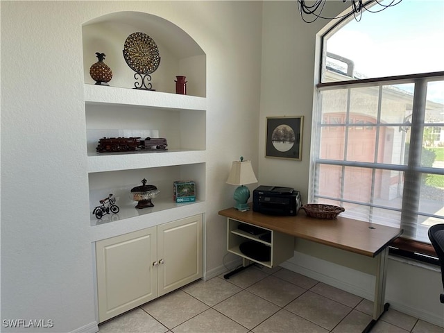 office with light tile patterned floors, baseboards, and built in features