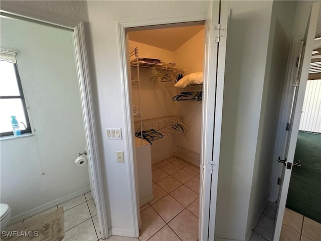 interior space featuring toilet and tile patterned floors