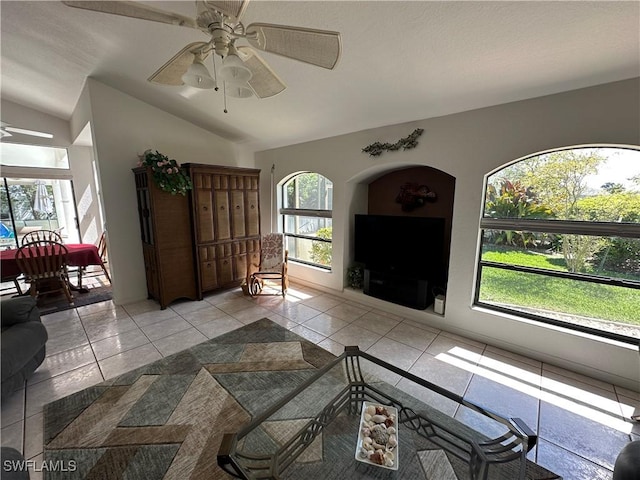 living room featuring a wealth of natural light, vaulted ceiling, and a ceiling fan