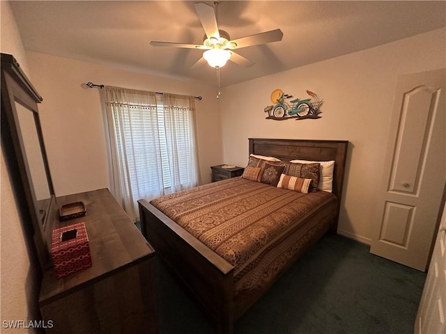 bedroom with ceiling fan and dark carpet