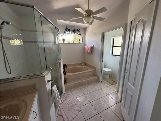 full bathroom featuring tile patterned flooring, toilet, a ceiling fan, a shower stall, and a bath