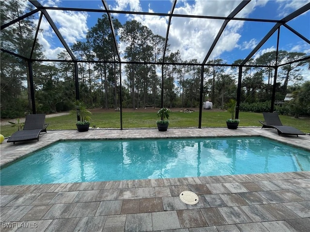 outdoor pool featuring a lanai, a patio area, and a yard