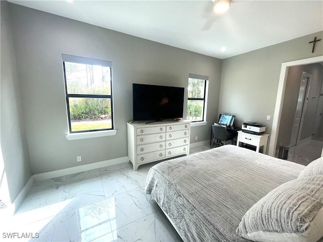 bedroom featuring marble finish floor, multiple windows, and baseboards