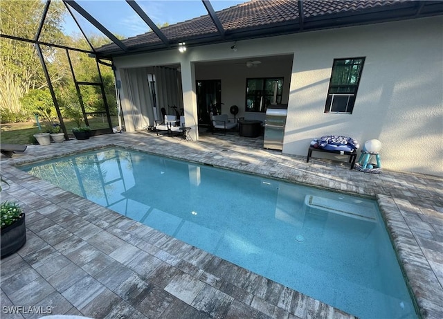 pool with a lanai and a patio area