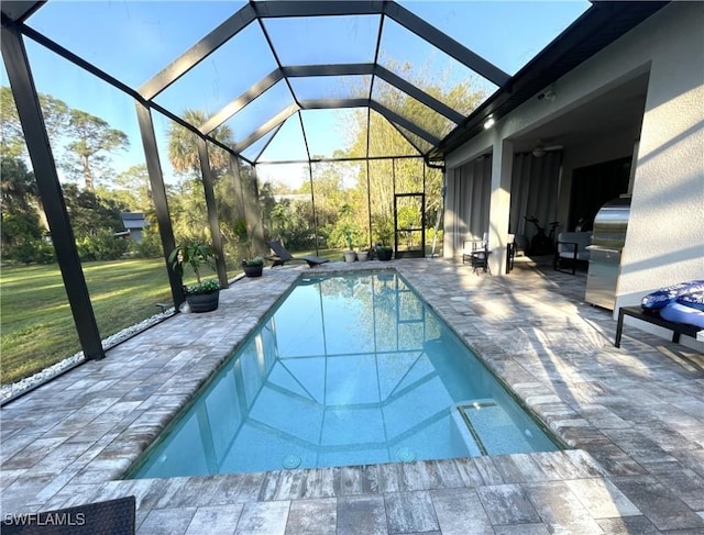 pool featuring a patio, a yard, and glass enclosure