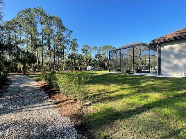 view of yard featuring glass enclosure