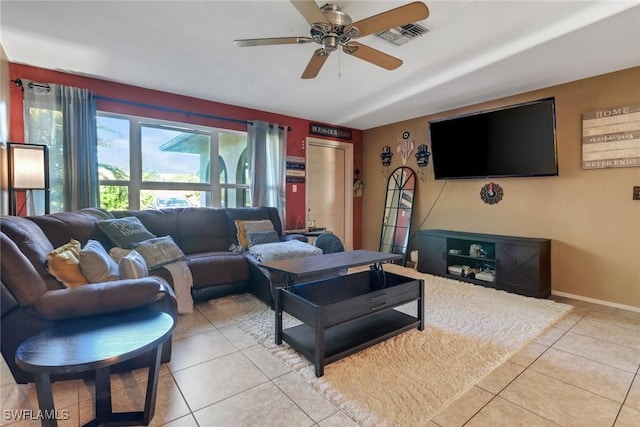 living room featuring light tile patterned floors, visible vents, baseboards, and ceiling fan