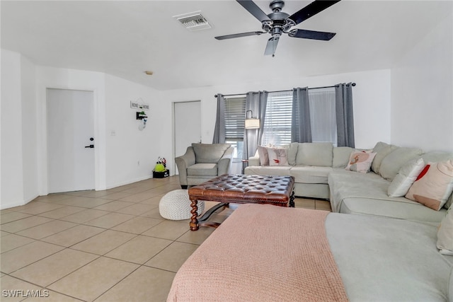 living area featuring light tile patterned flooring, visible vents, baseboards, and ceiling fan