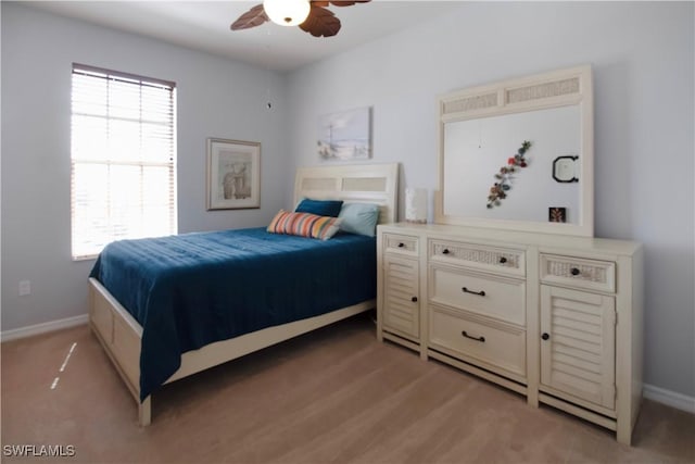 bedroom with ceiling fan and baseboards