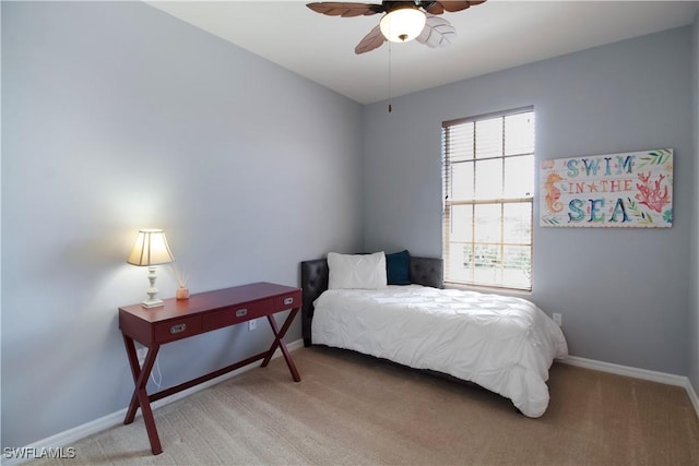 bedroom featuring light carpet, ceiling fan, and baseboards